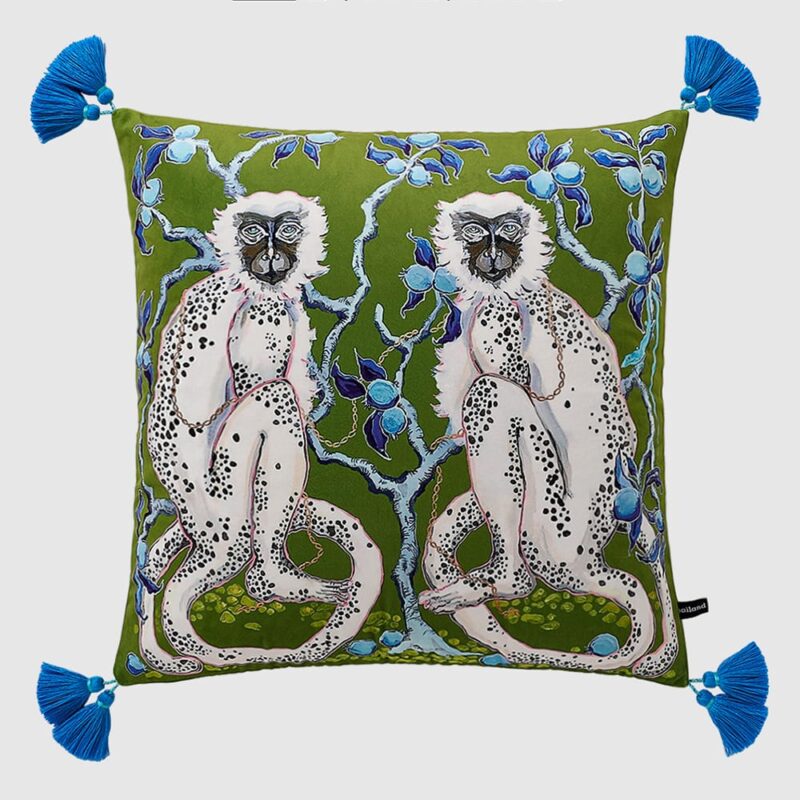 Forest green velvet cushion pillow cover with double-sided white monkeys, blue tree print, and blue tassels.