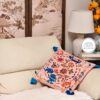 Apricot pink velvet pillow cover with oriental motifs including Qilin and blue tassels