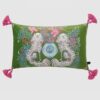 Green velvet lumbar pillow cover with white spaniel dogs, blue vase, and pink tassels.