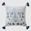 Velvet cushion pillow cover with organic light blue swirls, faded peach background, Victorian spaniel dogs, white-blue striped vase, and dark blue tassels