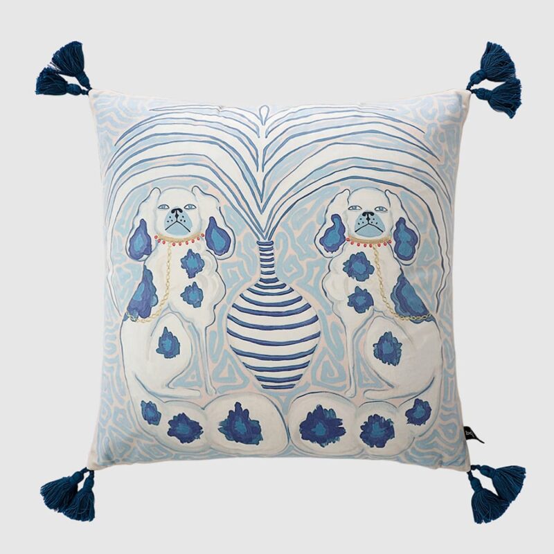 Velvet cushion pillow cover with organic light blue swirls, faded peach background, Victorian spaniel dogs, white-blue striped vase, and dark blue tassels
