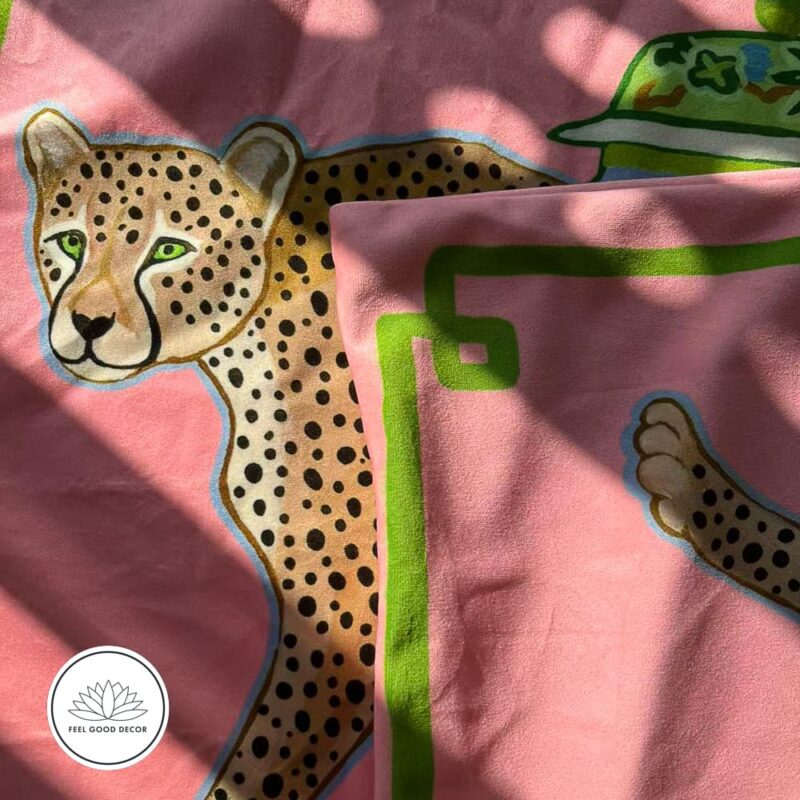 Pink micro velvet cushion cover with jungle leopard, antique porcelain jar, and green border.