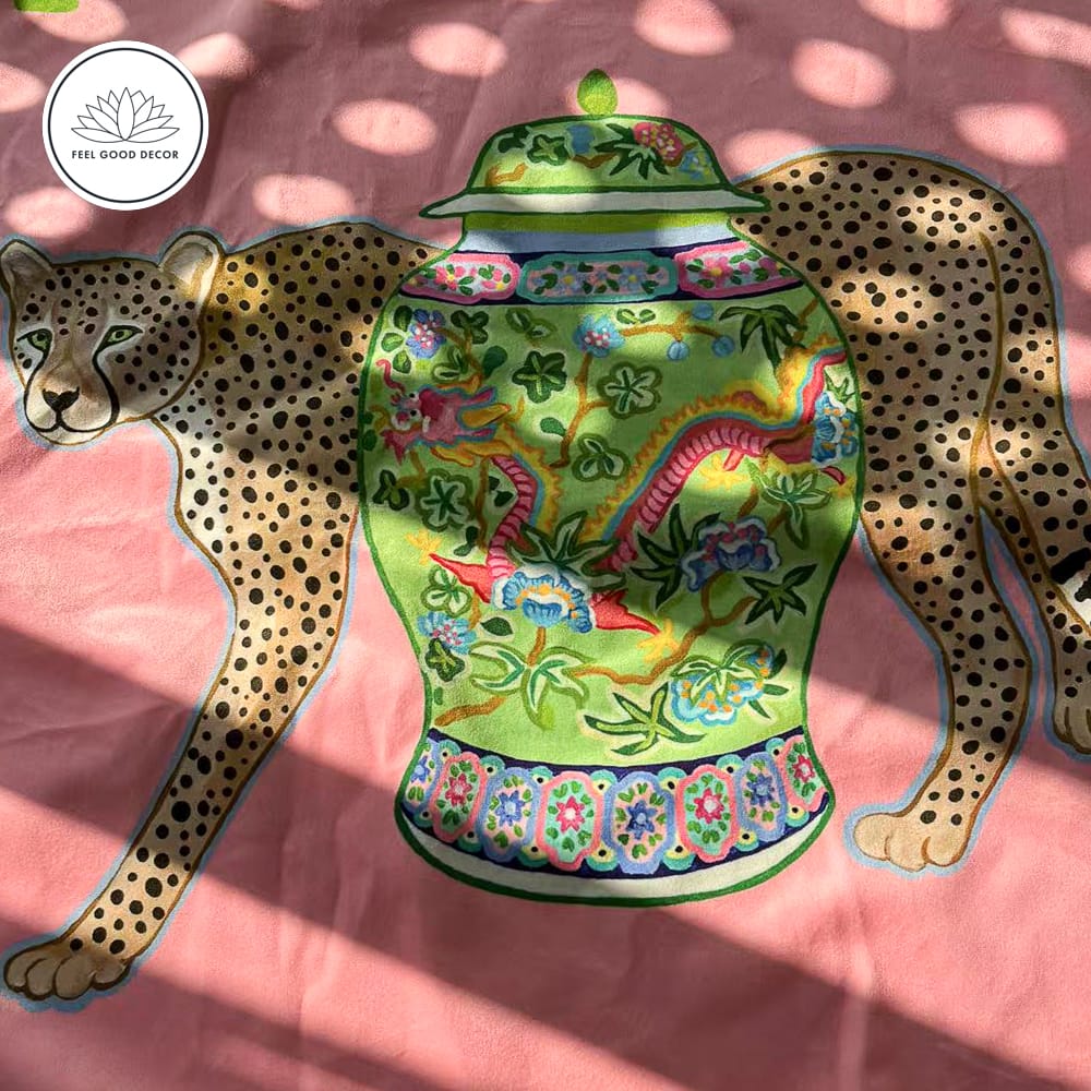 Pink micro velvet cushion cover with jungle leopard, antique porcelain jar, and green border.