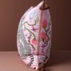 Pink velvet pillow cover with double-sided print of pink leopards, ceramic flower pot, white pigeons, butterflies, and rust tassels